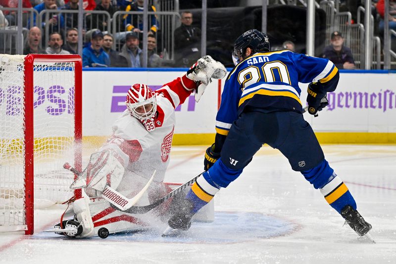 Dec 12, 2023; St. Louis, Missouri, USA;  Detroit Red Wings goaltender Ville Husso (35) makes a save against St. Louis Blues left wing Brandon Saad (20) during the second period at Enterprise Center. Mandatory Credit: Jeff Curry-USA TODAY Sports