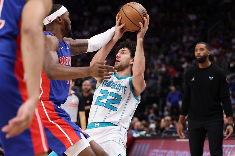 DETROIT, MICHIGAN - JANUARY 03: Vasilije Micic #22 of the Charlotte Hornets tries to control the ball next to Paul Reed #7 of the Detroit Pistons during the first half at Little Caesars Arena on January 03, 2025 in Detroit, Michigan. NOTE TO USER: User expressly acknowledges and agrees that, by downloading and or using this photograph, User is consenting to the terms and conditions of the Getty Images License. (Photo by Gregory Shamus/Getty Images)