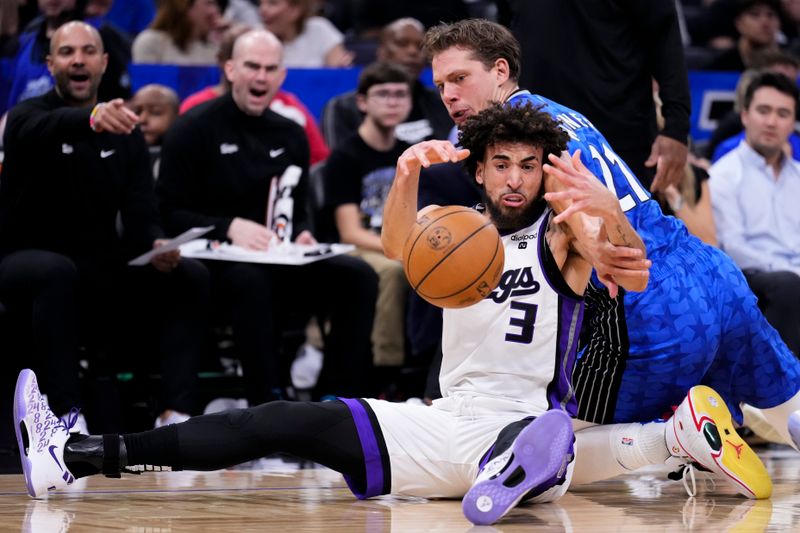 ORLANDO, FLORIDA - MARCH 23: Moritz Wagner #21 of the Orlando Magic fouls Chris Duarte #3 of the Sacramento Kings during the first quarter at Kia Center on March 23, 2024 in Orlando, Florida. NOTE TO USER: User expressly acknowledges and agrees that, by downloading and or using this photograph, User is consenting to the terms and conditions of the Getty Images License Agreement. (Photo by Rich Storry/Getty Images)