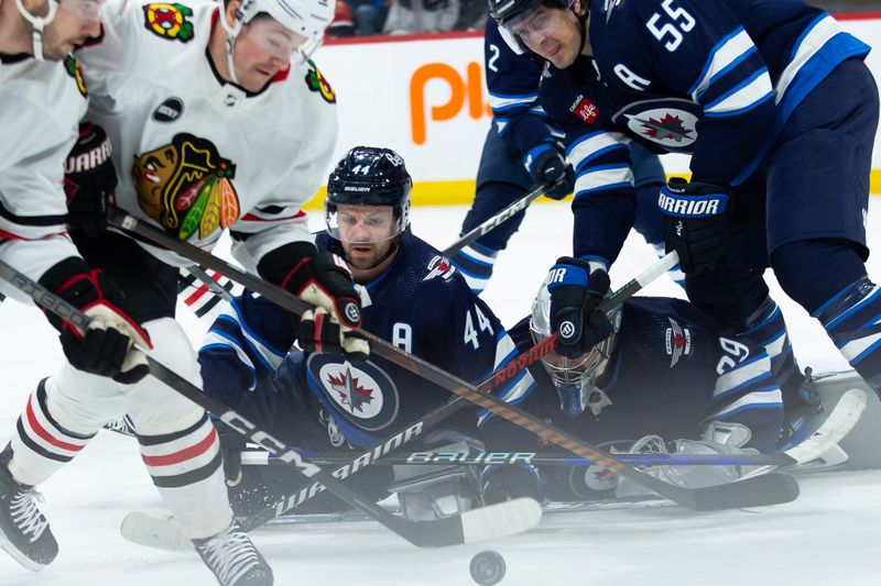 Jan 11, 2024; Winnipeg, Manitoba, CAN; Chicago Blackhawks forward Ryan Donato (8), Winnipeg Jets defenseman Josh Morrissey (44) and Winnipeg Jets forward Mark Scheifele (55) looks for the puck in front of Winnipeg Jets goalie Connor Hellebuyck (37) during the first period at Canada Life Centre. Mandatory Credit: Terrence Lee-USA TODAY Sports