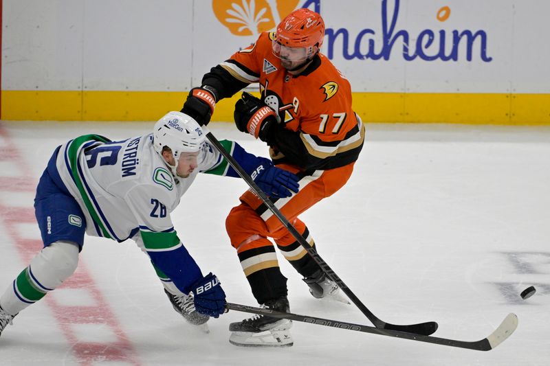 Nov 5, 2024; Anaheim, California, USA;  Vancouver Canucks defenseman Erik Brannstrom (26) and Anaheim Ducks left wing Alex Killorn (17) battle on the ice in the second period at Honda Center. Mandatory Credit: Jayne Kamin-Oncea-Imagn Images