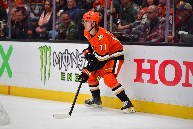 Oct 16, 2024; Anaheim, California, USA; Anaheim Ducks center Trevor Zegras (11) controls the puck against Utah Hockey Club during the second period at Honda Center. Mandatory Credit: Gary A. Vasquez-Imagn Images