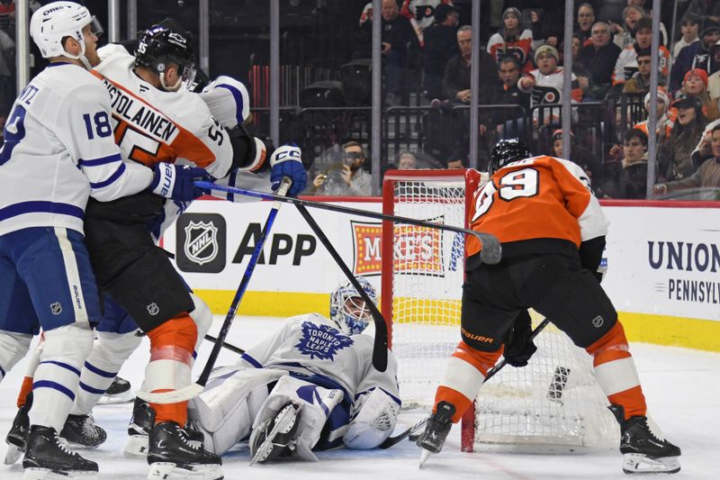 Jan 7, 2025; Philadelphia, Pennsylvania, USA; Toronto Maple Leafs goaltender Joseph Woll (60) makes a save against Philadelphia Flyers right wing Matvei Michkov (39) during the first period at Wells Fargo Center. Mandatory Credit: Eric Hartline-Imagn Images