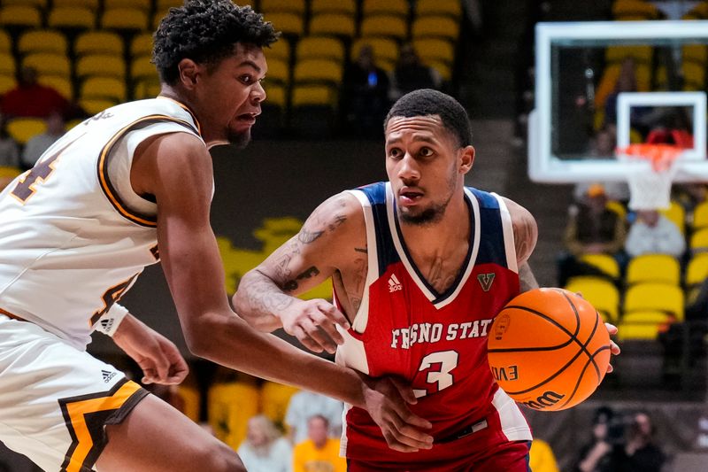 Jan 31, 2023; Laramie, Wyoming, USA; Fresno State Bulldogs guard Isaiah Hill (3) drives against Wyoming Cowboys forward Caden Powell (44) during the second half at Arena-Auditorium. Mandatory Credit: Troy Babbitt-USA TODAY Sports