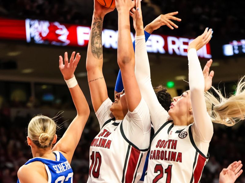 Jan 15, 2024; Columbia, South Carolina, USA; South Carolina Gamecocks center Kamilla Cardoso (10) grabs a rebound over forward Chloe Kitts (21) and Kentucky Wildcats guard Maddie Scherr (22) in the first half at Colonial Life Arena. Mandatory Credit: Jeff Blake-USA TODAY Sports