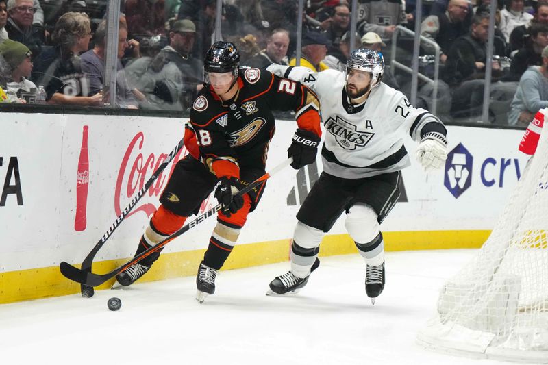 Apr 13, 2024; Los Angeles, California, USA; Anaheim Ducks defenseman Gustav Lindstrom (28) and LA Kings right wing Arthur Kaliyev (34) battle for the puck in the second period at Crypto.com Arena. Mandatory Credit: Kirby Lee-USA TODAY Sports