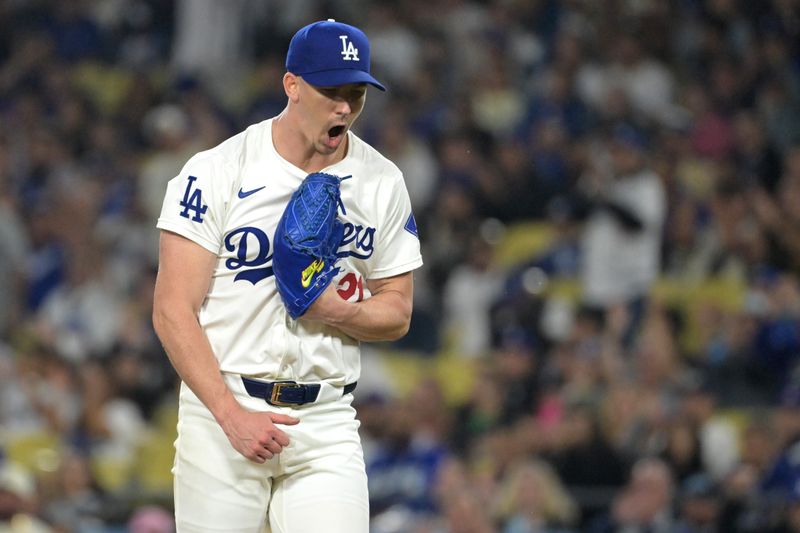 Sep 26, 2024; Los Angeles, California, USA;  Los Angeles Dodgers starting pitcher Walker Buehler (21) reacts after a double play to end the fourth inning against the San Diego Padres at Dodger Stadium. Mandatory Credit: Jayne Kamin-Oncea-Imagn Images