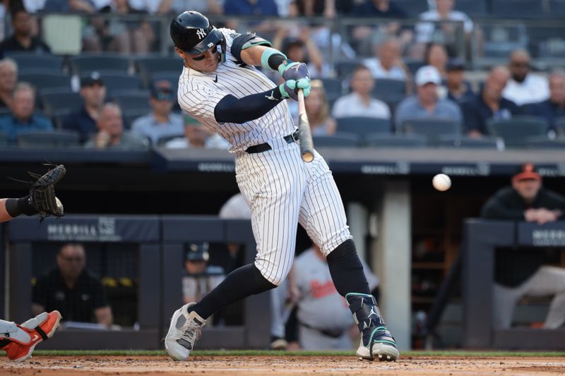 Jun 18, 2024; Bronx, New York, USA; New York Yankees center fielder Aaron Judge (99) singles during the first inning against the Baltimore Orioles at Yankee Stadium. Mandatory Credit: Vincent Carchietta-USA TODAY Sports