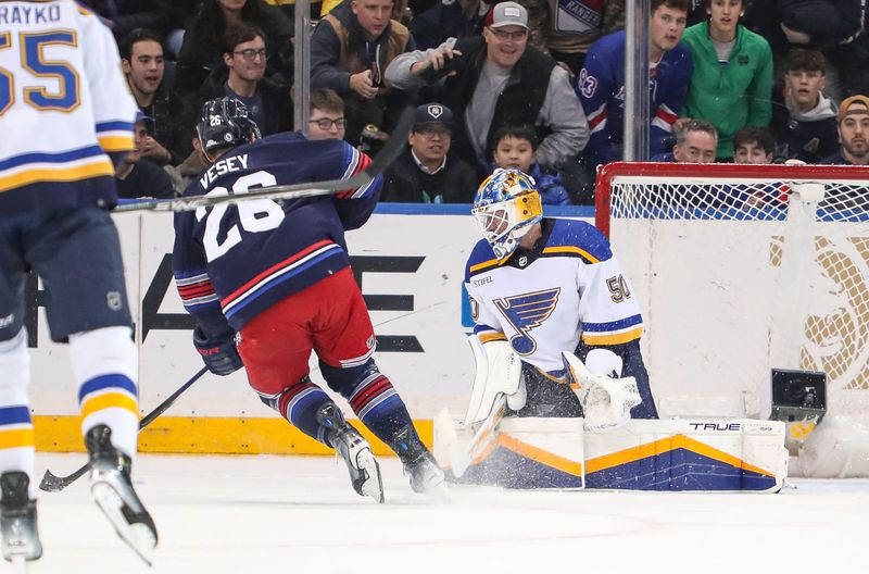 Mar 9, 2024; New York, New York, USA: New York Rangers left wing Jimmy Vesey (26) scores a goal on St. Louis Blues goalie Jordan Binnington (50) during the first period at Madison Square Garden. Mandatory Credit: Danny Wild-USA TODAY Sports