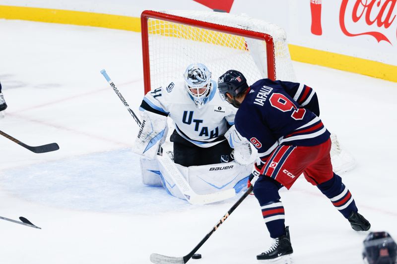 Oct 26, 2025; Winnipeg, Manitoba, CAN; Utah Utah Mammoth goalie Vitek Vanecek (41) watches Winnipeg Jets forward Alex Iafallo (9) during the second period at Canada Life Centre. Mandatory Credit: Terrence Lee-Imagn Images