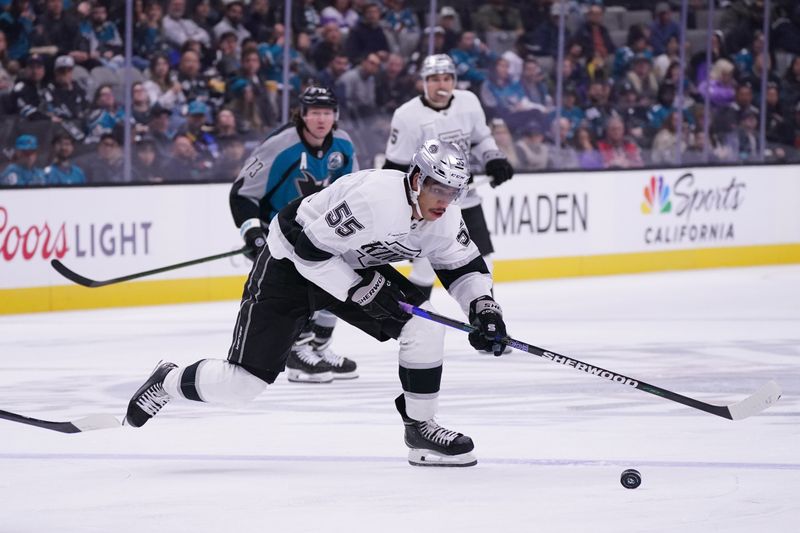 Nov 20, 2025; San Jose, California, USA;  Los Angeles Kings right winger Quinton Byfield (55) advances the puck past San Jose Sharks center Tyler Toffoli (73) in the second period at SAP Center at San Jose. Mandatory Credit: David Gonzales-Imagn Images