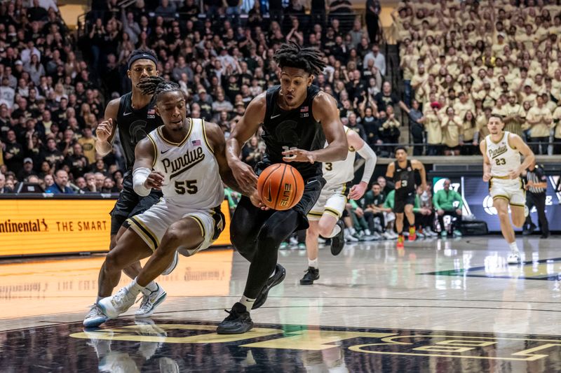 Mar 2, 2024; West Lafayette, Indiana, USA; Michigan State Spartans guard A.J. Hoggard (11) steals the ball from Purdue Boilermakers guard Lance Jones (55) during the second half at Mackey Arena. Mandatory Credit: Marc Lebryk-USA TODAY Sports