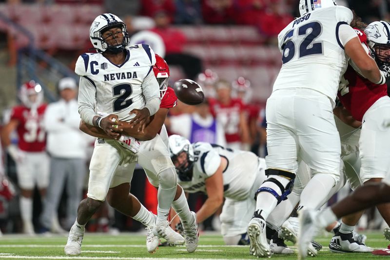 Sep 30, 2023; Fresno, California, USA; Nevada Wolf Pack quarterback Brendon Lewis (2) fumbles the ball after being hit by Fresno State Bulldogs defensive lineman Jacob Holmes (23) in the fourth quarter at Valley Children's Stadium. Mandatory Credit: Cary Edmondson-USA TODAY Sports