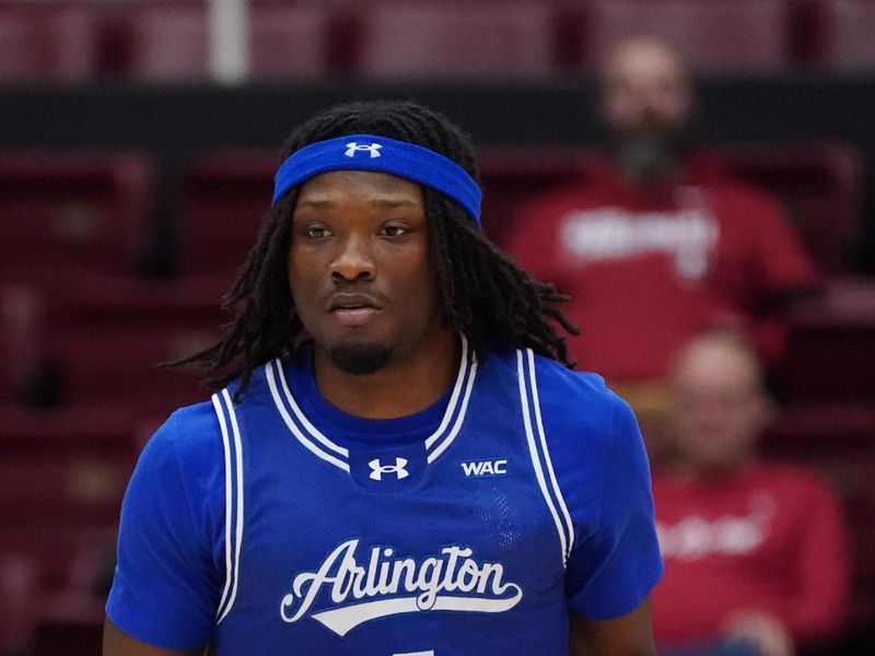 Dec 17, 2025; Stanford, California, USA;  Texas-Arlington  Mavericks guard Marcus Rigsby, Jr. (4) dribbles upcourt against the Stanford Cardinal in the first half at Maples Pavilion. Mandatory Credit: David Gonzales-Imagn Images
