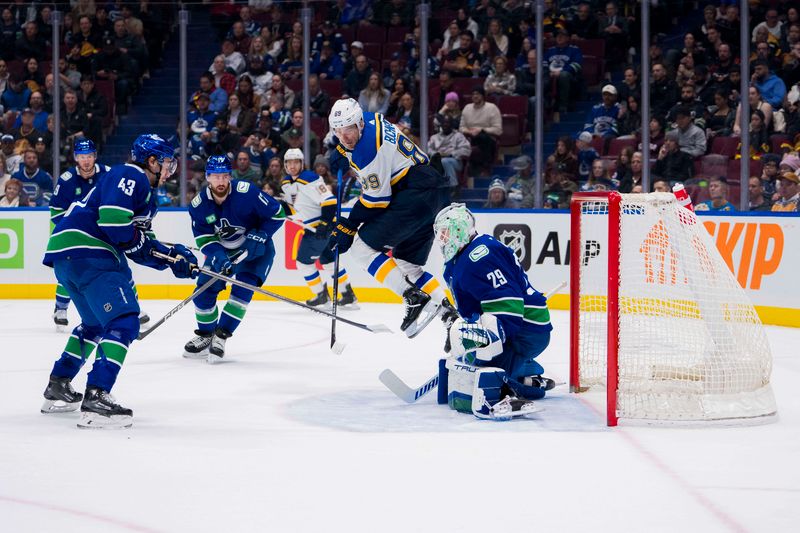 Jan 24, 2024; Vancouver, British Columbia, CAN; Vancouver Canucks defenseman Quinn Hughes (43) and St. Louis Blues forward Pavel Buchnevich (89) watch as the shot from forward Jake Neighbours (63) beats goalie Casey DeSmith (29) in the first period at Rogers Arena. Mandatory Credit: Bob Frid-USA TODAY Sports