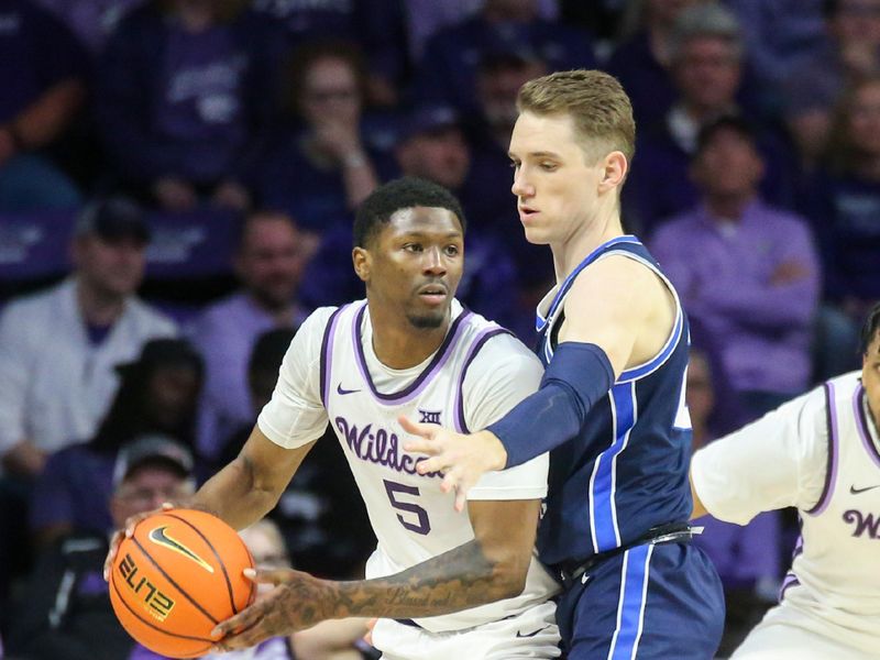 Feb 24, 2024; Manhattan, Kansas, USA; Kansas State Wildcats guard Cam Carter (5) is guarded by Brigham Young Cougars guard Spencer Johnson (20) during the second half at Bramlage Coliseum. Mandatory Credit: Scott Sewell-USA TODAY Sports