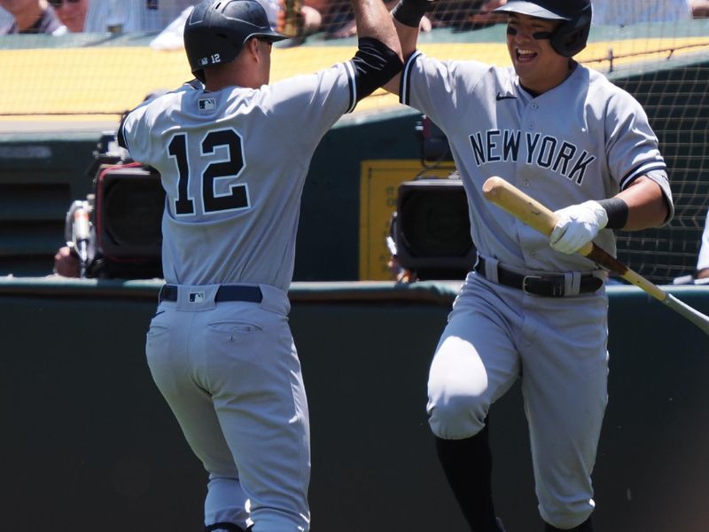 Jun 29, 2023; Oakland, California, USA; New York Yankees left fielder Isiah Kiner-Falefa (12) celebrates with shortstop Anthony Volpe (11) after hitting a solo home run against the Oakland Athletics during the second inning at Oakland-Alameda County Coliseum. Mandatory Credit: Kelley L Cox-USA TODAY Sports