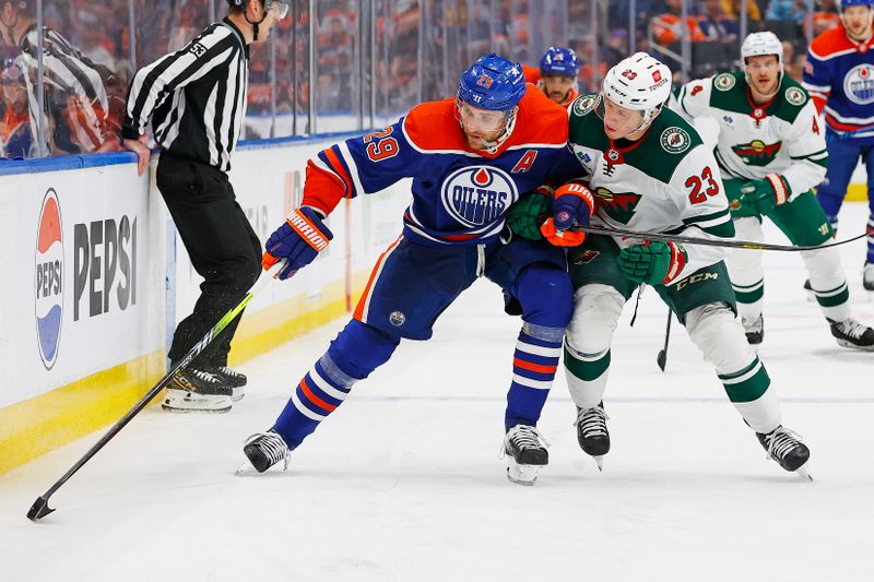 Feb 23, 2024; Edmonton, Alberta, CAN; Edmonton Oilers forward Leon Draisaitl (29) protects the puck from Minnesota Wild forward Marco Rossi (23) during the third period at Rogers Place. Mandatory Credit: Perry Nelson-USA TODAY Sports