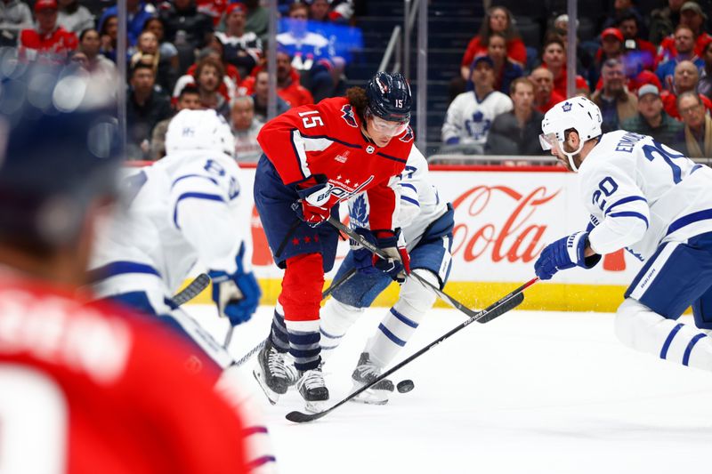 Mar 20, 2024; Washington, District of Columbia, USA; Washington Capitals left wing Sonny Milano (15) battles for the puck with Toronto Maple Leafs defenseman Joel Edmundson (20) during the first period at Capital One Arena. Mandatory Credit: Amber Searls-USA TODAY Sports