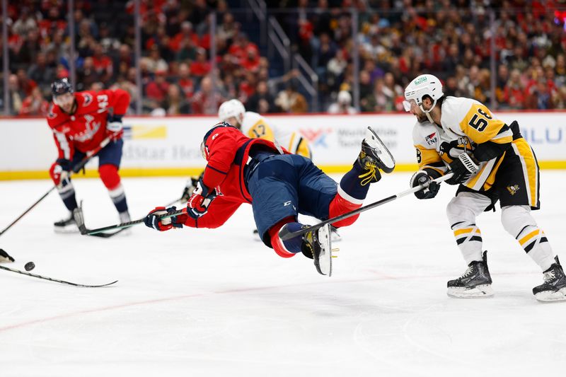 Apr 4, 2024; Washington, District of Columbia, USA; Washington Capitals left wing Alex Ovechkin (8) shoots the puck while being tripped by Pittsburgh Penguins defenseman Kris Letang (58) in the third period at Capital One Arena. Mandatory Credit: Geoff Burke-USA TODAY Sports