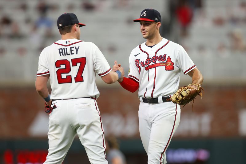 Aug 16, 2023; Atlanta, Georgia, USA; Atlanta Braves third baseman Austin Riley (27) and first baseman Matt Olson (28) celebrate after a victory against the New York Yankees at Truist Park. Mandatory Credit: Brett Davis-USA TODAY Sports
