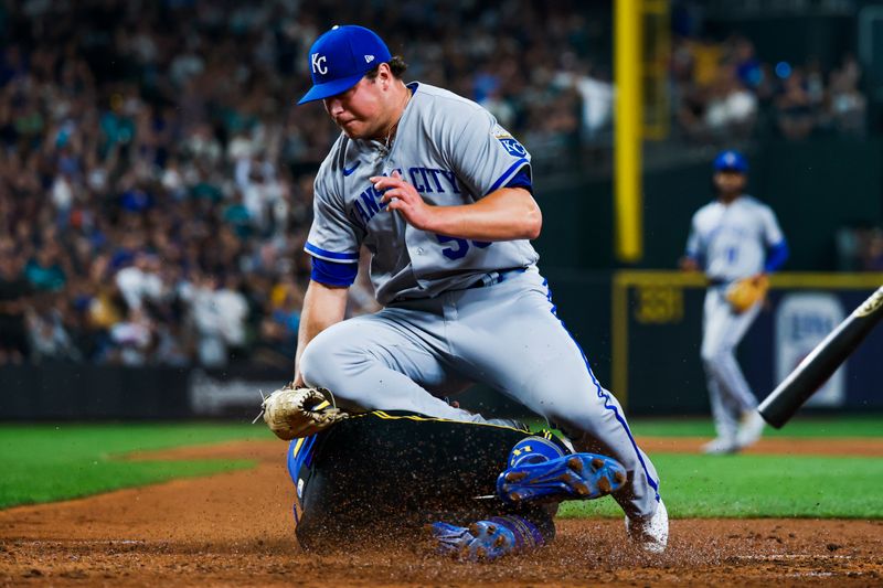 Aug 25, 2023; Seattle, Washington, USA; Kansas City Royals relief pitcher Austin Cox (53) fails to apply a tag on Seattle Mariners right fielder Teoscar Hernandez (35) in time to prevent Hernandez from scoring a run on a wild pitch during the fifth inning at T-Mobile Park. Mandatory Credit: Joe Nicholson-USA TODAY Sports