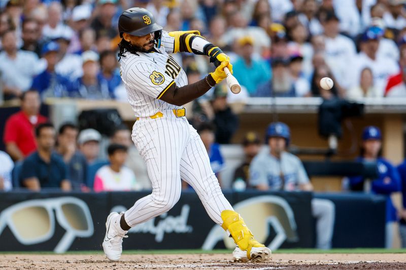 Jul 31, 2024; San Diego, California, USA; San Diego Padres catcher Luis Campusano (12) hits a RBI single during the second inning against the Los Angeles Dodgers at Petco Park. Mandatory Credit: David Frerker-USA TODAY Sports