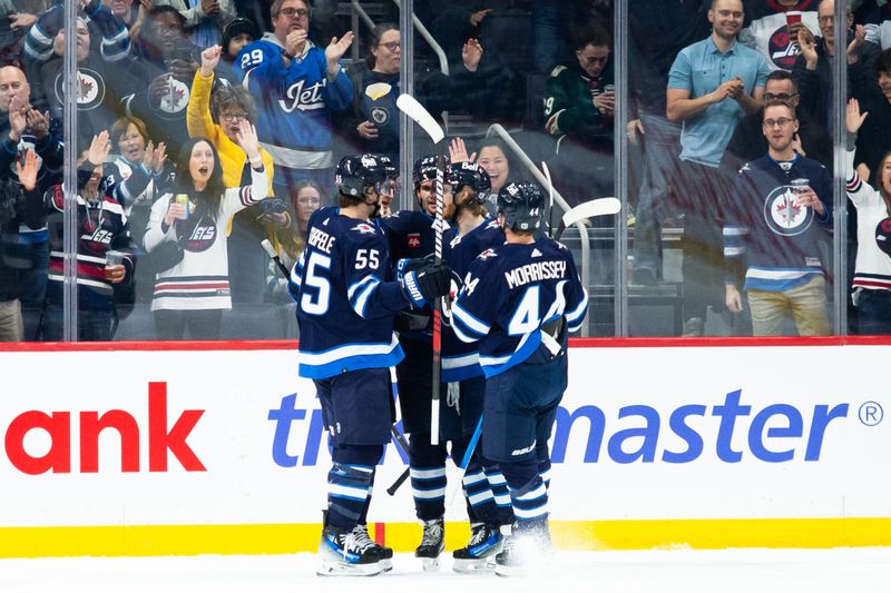 Feb 20, 2024; Winnipeg, Manitoba, CAN; Winnipeg Jets forward Gabriel Vilardi (13) is congratulated by his team mates on his goal against the Minnesota Wild during the first period at Canada Life Centre. Mandatory Credit: Terrence Lee-USA TODAY Sports