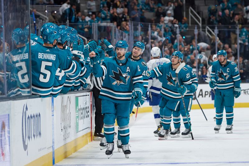 Oct 29, 2022; San Jose, California, USA; San Jose Sharks defenseman Erik Karlsson (65) celebrates at the bench after scoring the game-tying goal against the Tampa Bay Lightning during the third period at SAP Center at San Jose. Mandatory Credit: Robert Edwards-USA TODAY Sports