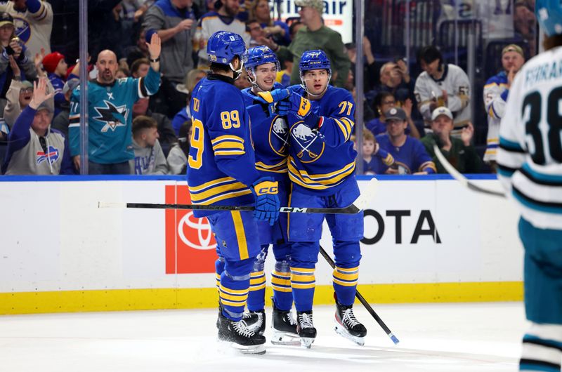 Mar 4, 2025; Buffalo, New York, USA;  Buffalo Sabres right wing JJ Peterka (77) celebrates his goal with teammates during the second period against the San Jose Sharks at KeyBank Center. Mandatory Credit: Timothy T. Ludwig-Imagn Images