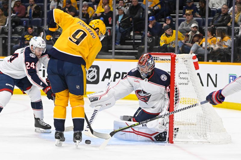 Jan 17, 2023; Nashville, Tennessee, USA;  Columbus Blue Jackets goaltender Daniil Tarasov (40) blocks the shot of Nashville Predators left wing Filip Forsberg (9) during the third period at Bridgestone Arena. Mandatory Credit: Steve Roberts-USA TODAY Sports