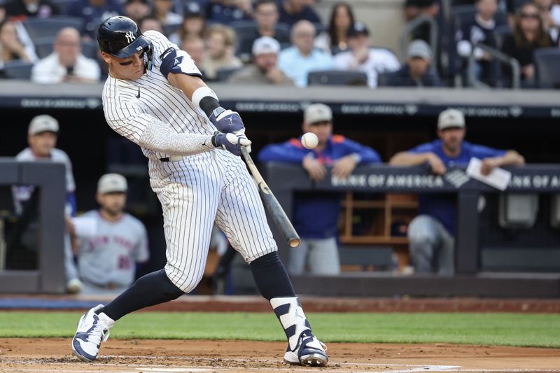 May 18, 2025; Bronx, New York, USA;  New York Yankees right fielder Aaron Judge (99) hits a double in the first inning against the New York Mets at Yankee Stadium. Mandatory Credit: Wendell Cruz-Imagn Images