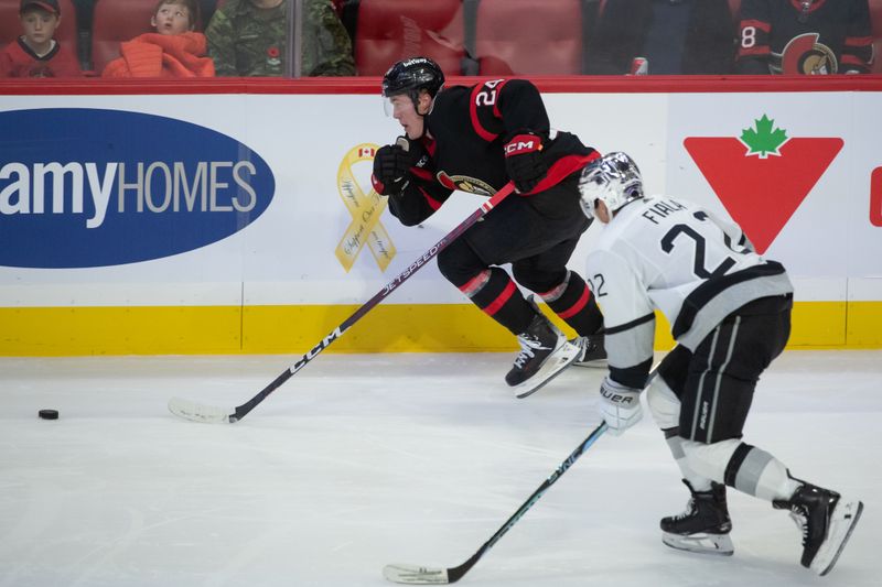 Nov 2, 2023; Ottawa, Ontario, CAN; Ottawa Senators defenseman Jacob Bernard-Docker (24) and Los Angeles Kings left wing Kevin Fiala (22) chase the puck in the third period at the Canadian Tire Centre. Mandatory Credit: Marc DesRosiers-USA TODAY Sports