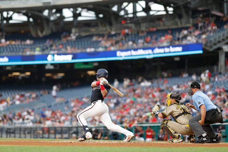 Jul 24, 2024; Washington, District of Columbia, USA; Washington Nationals outfielder Lane Thomas (28) singles against the San Diego Padres during the first inning at Nationals Park. Mandatory Credit: Geoff Burke-USA TODAY Sports