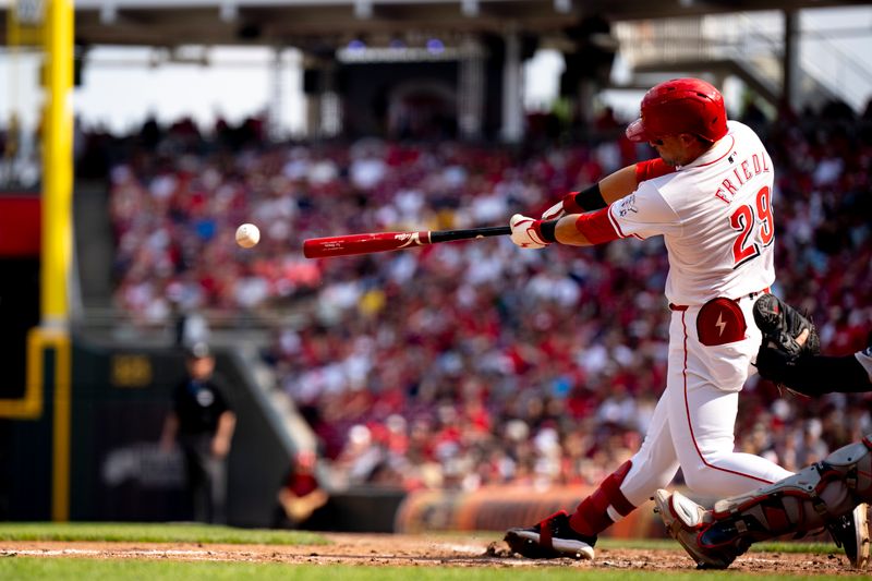 Jun 22, 2024; Cincinnati, Ohio, USA; Cincinnati Reds outfielder TJ Friedl (29) hits a base hit in the fifth inning of the MLB baseball game between the Cincinnati Reds and the Boston Red Sox at Great American Ball Park in Cincinnati on Saturday, June 22, 2024. Mandatory Credit: Albert Cesare-The Cincinnati Enquirer-USA TODAY Sports