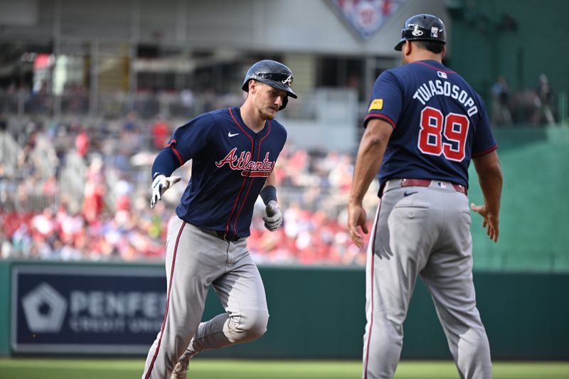 Jun 8, 2024; Washington, District of Columbia, USA; Atlanta Braves catcher Sean Murphy (12) celebrates hitting a home run with third base coach Matt Tuiasosopo (89) during the seventh inning against the Washington Nationals at Nationals Park. Mandatory Credit: Rafael Suanes-USA TODAY Sports