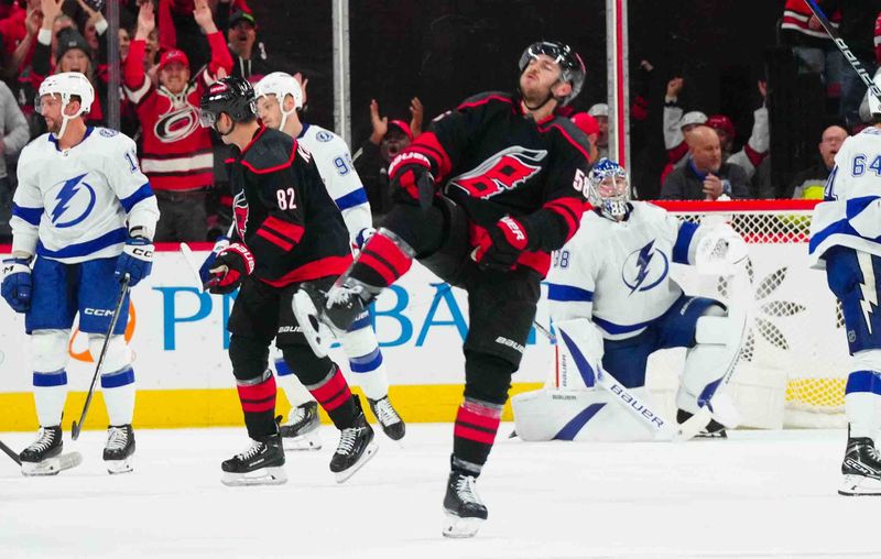 Nov 24, 2023; Raleigh, North Carolina, USA; Carolina Hurricanes left wing Michael Bunting (58) celebrates his goal past Tampa Bay Lightning goaltender Andrei Vasilevskiy (88) during the second period at PNC Arena. Mandatory Credit: James Guillory-USA TODAY Sports