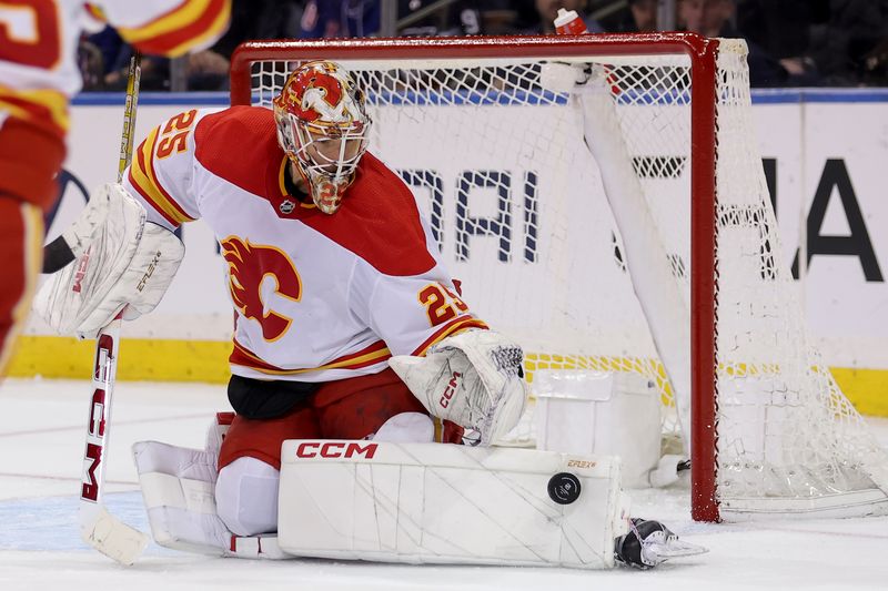 Feb 12, 2024; New York, New York, USA; Calgary Flames goaltender Jacob Markstrom (25) makes a save against the New York Rangers during the third period at Madison Square Garden. Mandatory Credit: Brad Penner-USA TODAY Sports