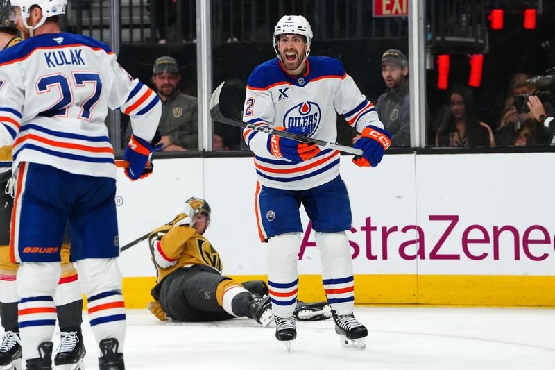 May 8, 2025; Las Vegas, Nevada, USA; Edmonton Oilers defenseman Evan Bouchard (2) protests a penalty called after interfering with Vegas Golden Knights center Ivan Barbashev (49) during the second period of game two of the second round of the 2025 Stanley Cup Playoffs at T-Mobile Arena. Mandatory Credit: Stephen R. Sylvanie-Imagn Images