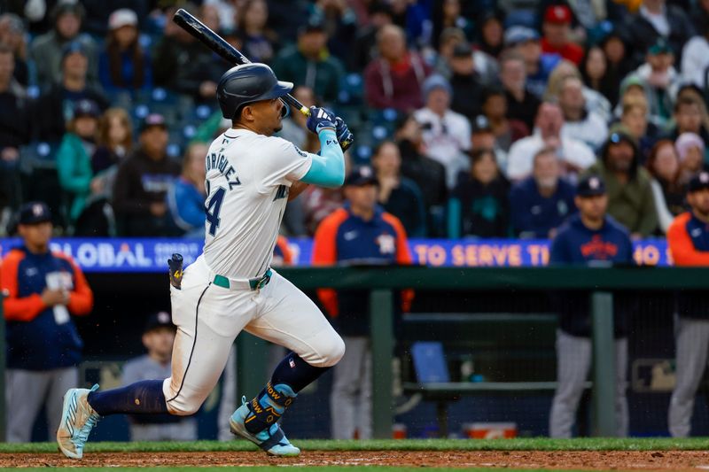 May 28, 2024; Seattle, Washington, USA; Seattle Mariners center fielder Julio Rodriguez (44) hits an RBI-infield single against the Houston Astros during the eighth inning at T-Mobile Park. Mandatory Credit: Joe Nicholson-USA TODAY Sports