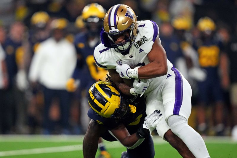 Jan 8, 2024; Houston, TX, USA; Washington Huskies wide receiver Rome Odunze (1) runs the ball against Michigan Wolverines defensive back Will Johnson (2) during the second quarter in the 2024 College Football Playoff national championship game at NRG Stadium. Mandatory Credit: Kirby Lee-USA TODAY Sports