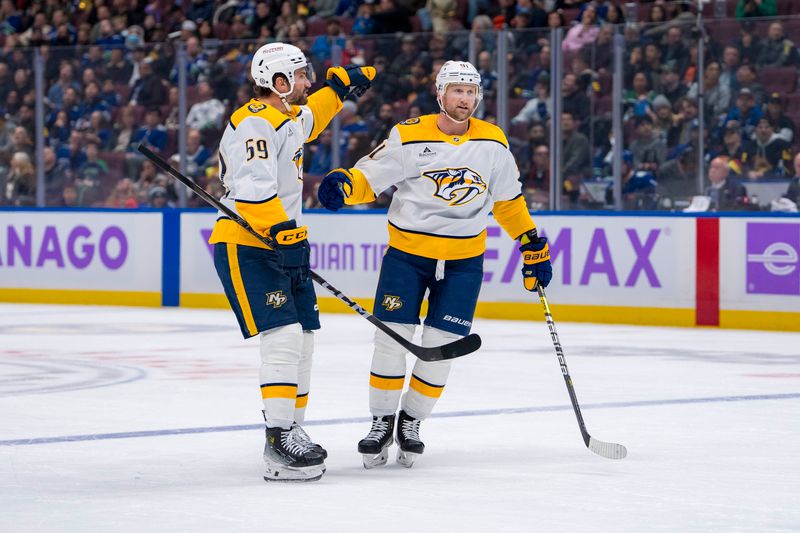 Nov 17, 2024; Vancouver, British Columbia, CAN; Nashville Predators defenseman Roman Josi (59) and forward Steven Stamkos (91) celebrate Stamkos’ first goal against the Vancouver Canucks during the second period at Rogers Arena. Mandatory Credit: Bob Frid-Imagn Images