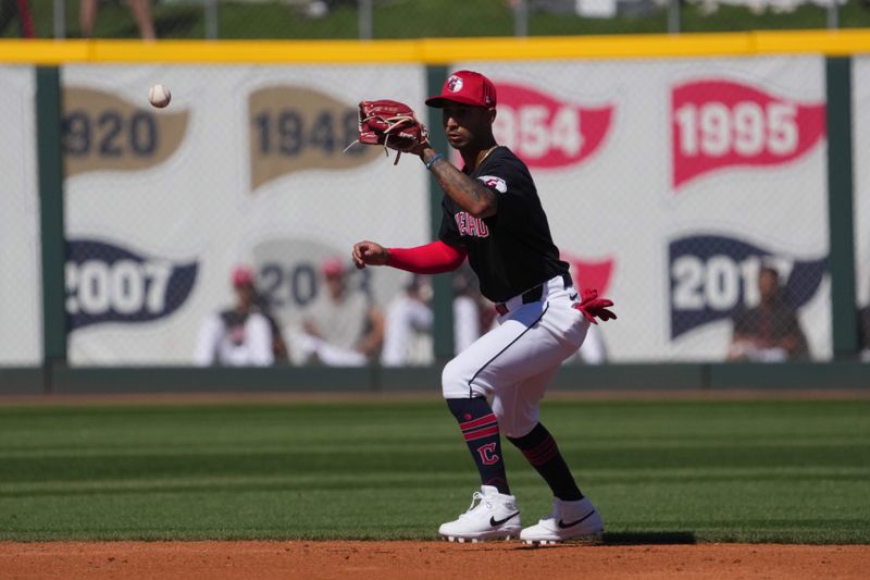 Mar 2, 2024; Goodyear, Arizona, USA; Cleveland Guardians shortstop Brayan Rocchio (4) fields a ground ball against the Kansas City Royals during the second inning at Goodyear Ballpark. Mandatory Credit: Joe Camporeale-USA TODAY Sports