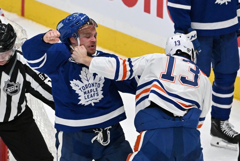 Mar 23, 2024; Toronto, Ontario, CAN; Toronto Maple Leafs forward Max Domi (11) fights with Edmonton Oilers forward Mattias Janmark (13) in the third period at Scotiabank Arena. Mandatory Credit: Dan Hamilton-USA TODAY Sports