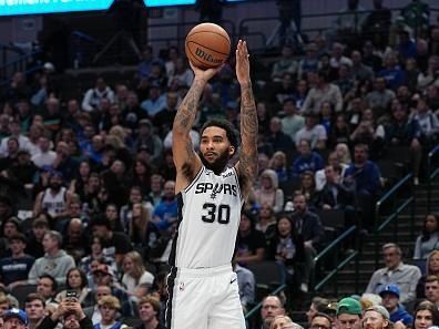 DALLAS, TX - DECEMBER 23: Julian Champagnie #30 of the San Antonio Spurs shoots a three point basket during the game against the Dallas Mavericks on December 23, 2023 at the American Airlines Center in Dallas, Texas. NOTE TO USER: User expressly acknowledges and agrees that, by downloading and or using this photograph, User is consenting to the terms and conditions of the Getty Images License Agreement. Mandatory Copyright Notice: Copyright 2023 NBAE (Photo by Glenn James/NBAE via Getty Images)