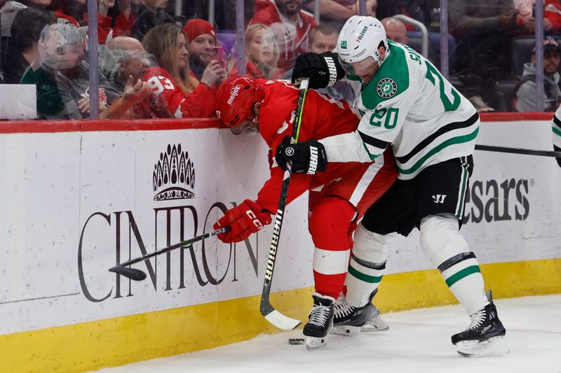 Jan 23, 2024; Detroit, Michigan, USA;  Detroit Red Wings left wing David Perron (57) and Dallas Stars defenseman Ryan Suter (20) battle for the puck in the second period at Little Caesars Arena. Mandatory Credit: Rick Osentoski-USA TODAY Sports