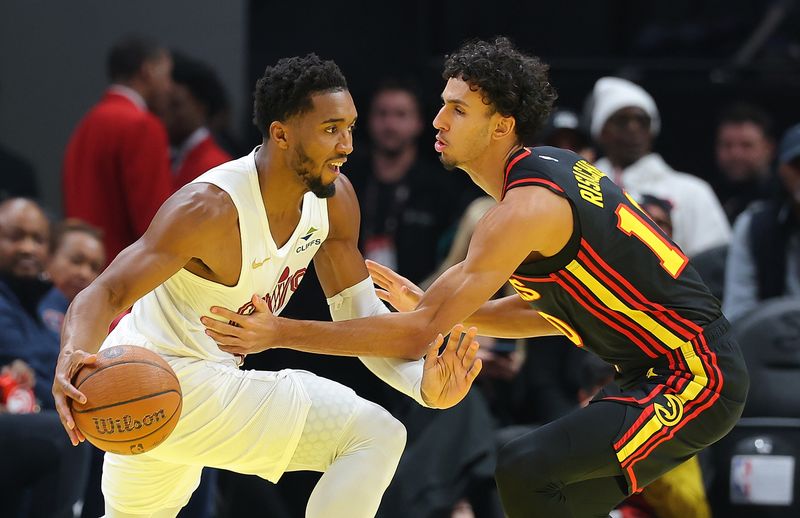 ATLANTA, GEORGIA - NOVEMBER 29:  Donovan Mitchell #45 of the Cleveland Cavaliers drives against Zaccharie Risacher #10 of the Atlanta Hawks during the first quarter of the Emirates NBA Cup game at State Farm Arena on November 29, 2024 in Atlanta, Georgia.  NOTE TO USER: User expressly acknowledges and agrees that, by downloading and/or using this photograph, user is consenting to the terms and conditions of the Getty Images License Agreement.  (Photo by Kevin C. Cox/Getty Images)