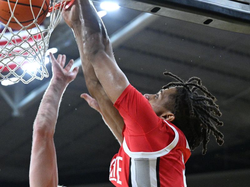 Feb 2, 2024; Iowa City, Iowa, USA; Ohio State Buckeyes forward Devin Royal (21) completes a slam dunk over Iowa Hawkeyes forward Ben Krikke (23) during the first half at Carver-Hawkeye Arena. Mandatory Credit: Jeffrey Becker-USA TODAY Sports