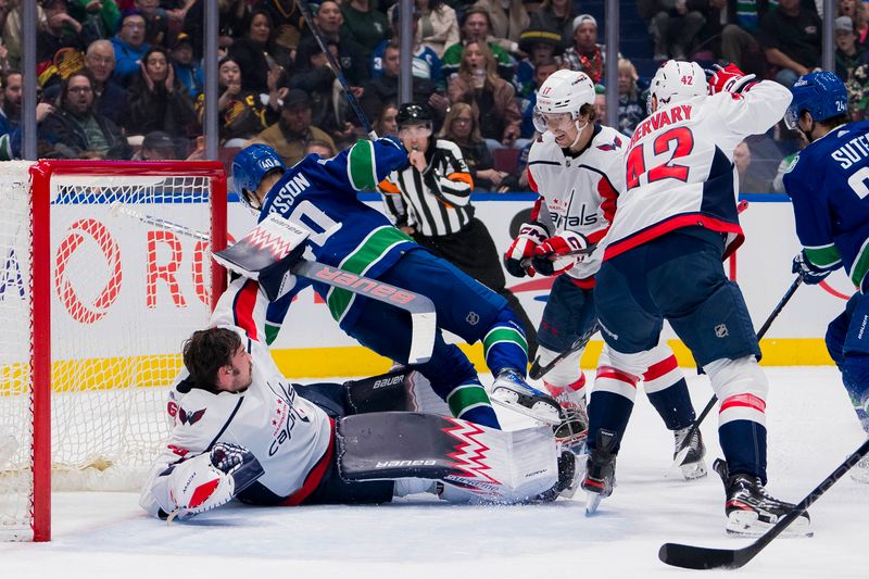 Mar 16, 2024; Vancouver, British Columbia, CAN; Washington Capitals forward Dylan Strome (17) watches ans goalie Charlie Lindgren (79) collides a with Vancouver Canucks forward Elias Pettersson (40) in the first period at Rogers Arena. Mandatory Credit: Bob Frid-USA TODAY Sports