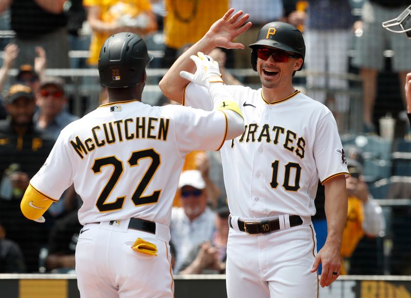 May 10, 2023; Pittsburgh, Pennsylvania, USA;  Pittsburgh Pirates designated hitter Andrew McCutchen (22) celebrates with left fielder Bryan Reynolds (10) after McCutchen hit a two run home run against the Colorado Rockies during the third inning at PNC Park. Mandatory Credit: Charles LeClaire-USA TODAY Sports